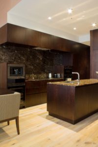 Kitchen with marble top and wooden shelf