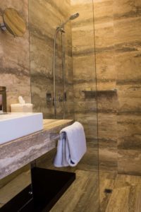 Hand shower and towels in bathroom