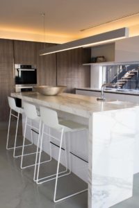 White Marbell made kitchen table with white color steel chairs