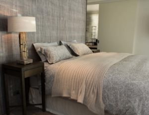 Wooden style lamp and gorgeous bed on grey colored wall room