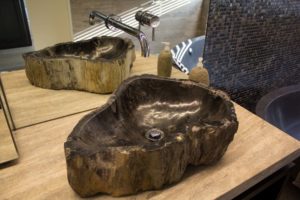 Silver color water tap with wooden style sink